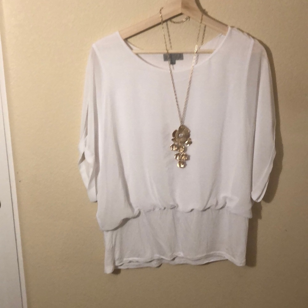 Sheer blouse with sewn in tank top. Cotton hem